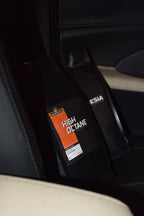 High octane roasted coffee blend labeled 'High Octane Blend' from Roastomatic inside a car.